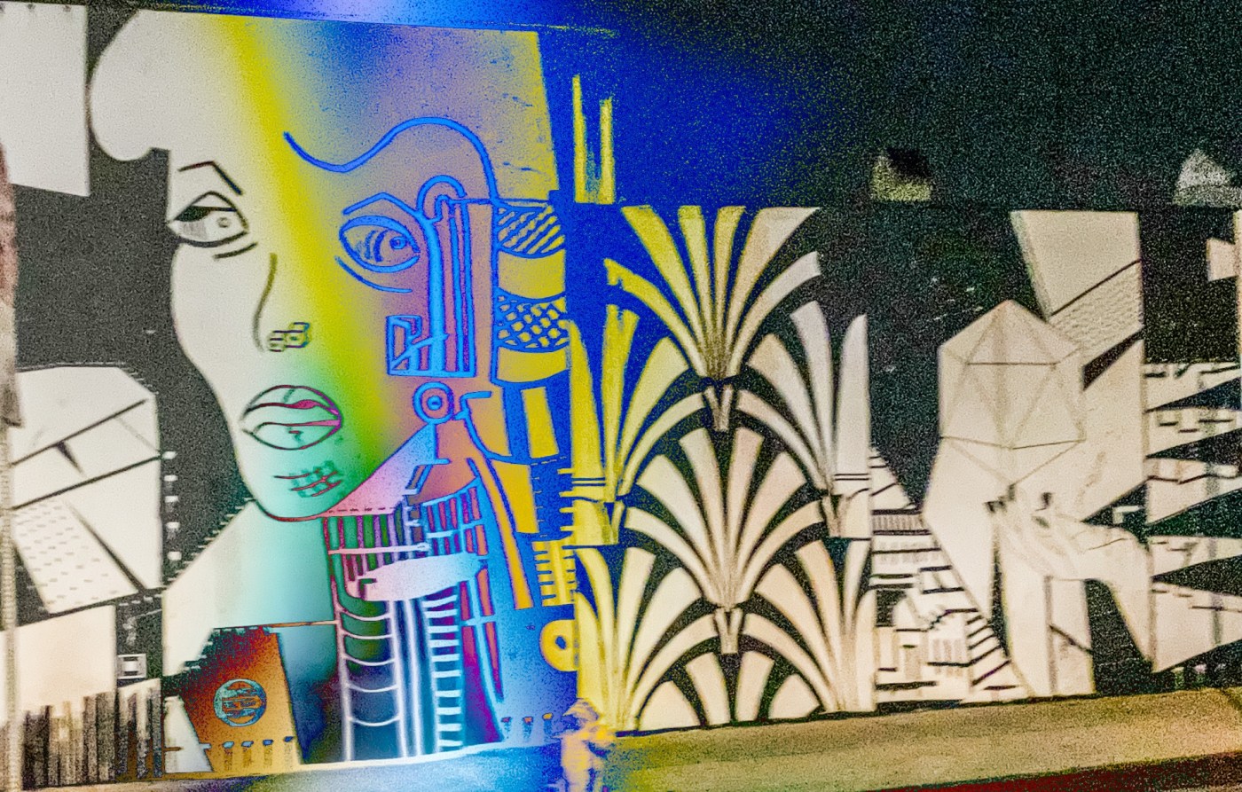 black and white art deco mural of a woman’s face on the side of a building in Los Angeles. edited with a rainbow like overlay